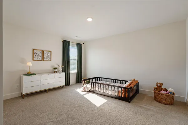 a spacious bedroom with a bed and a couch