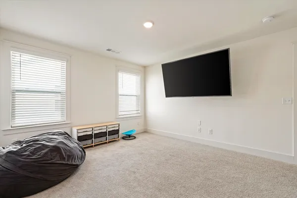 a room with a bed and a flat screen tv
