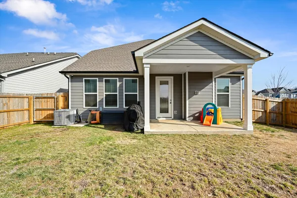 a view of a house with backyard porch and sitting area