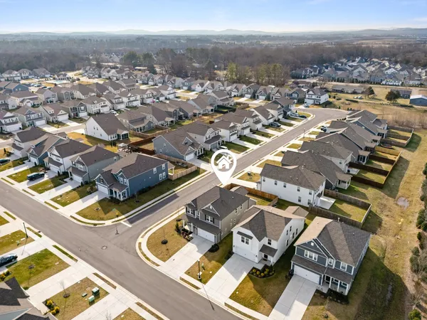 an aerial view of residential houses with parking