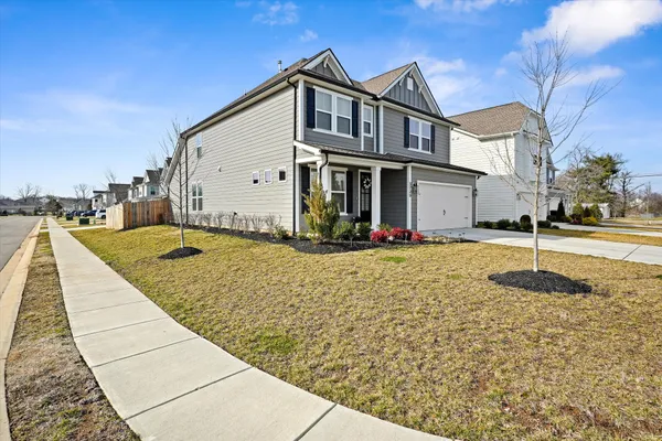 a front view of a house with a yard