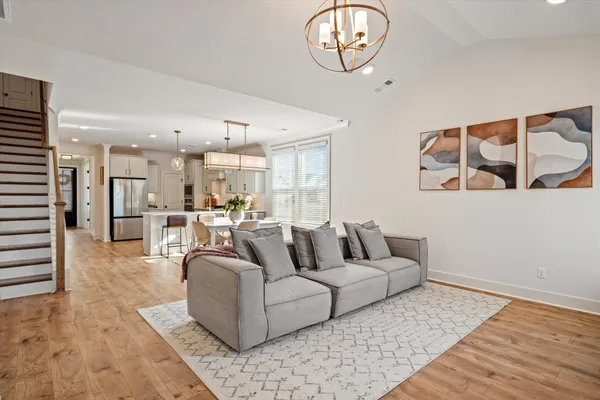 a living room with furniture and kitchen view