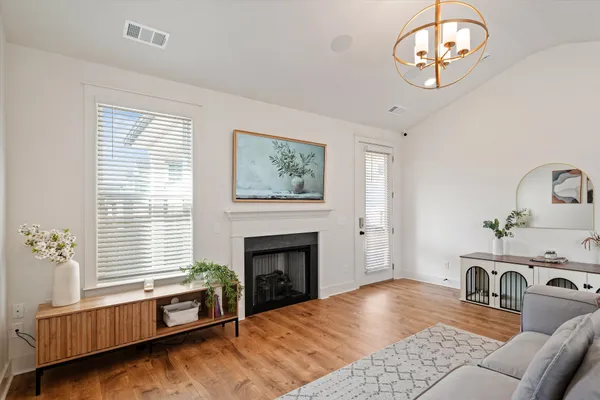 a living room with furniture fireplace and window