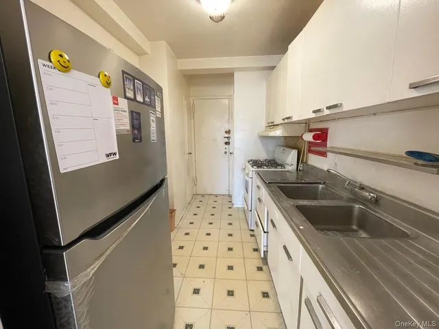 a kitchen with a sink and a refrigerator