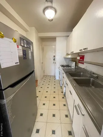 a kitchen with granite countertop a sink and a stove top oven