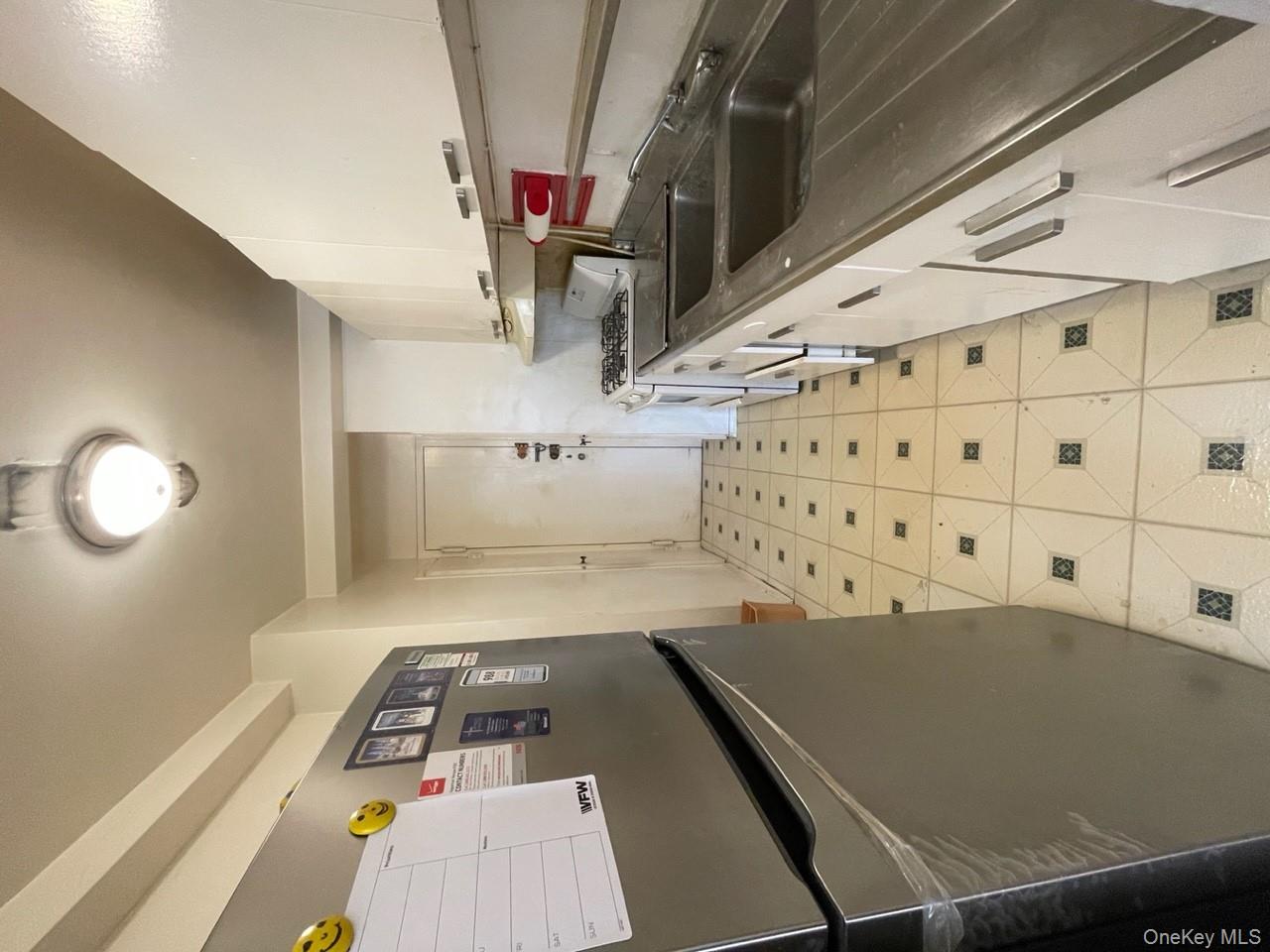 3 Fordham Hill Ovl, Unit 4G Bronx, NY 10468 - Photo 5 of 14 a kitchen with granite countertop a sink and a stove top oven
