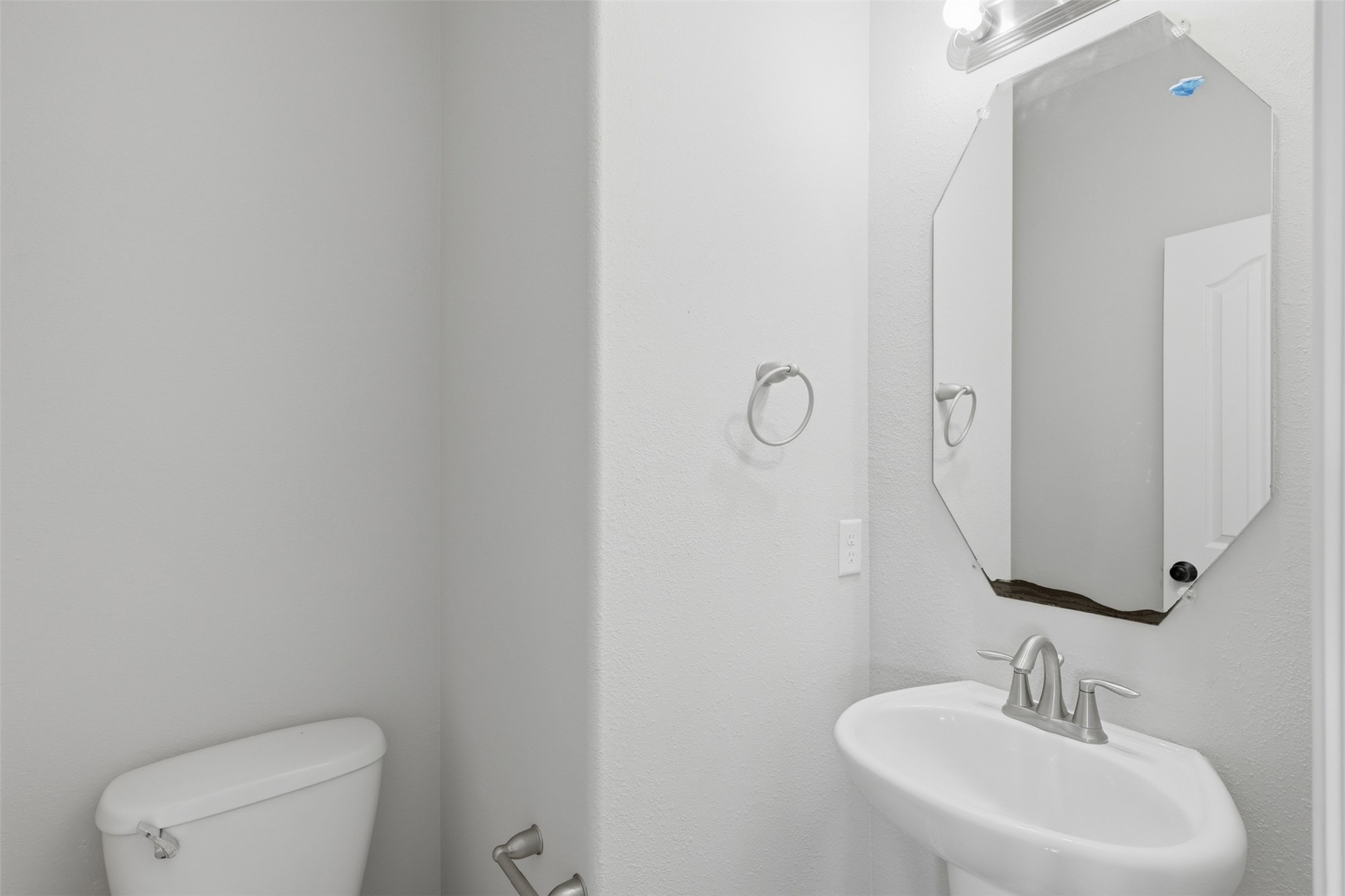 25926 Morgan Springs Spring, TX 77373 - Photo 17 of 49 Convenient first-floor powder room is thoughtfully located for guests and features a pedestal sink, and neutral finishes that complement the home's timeless design.