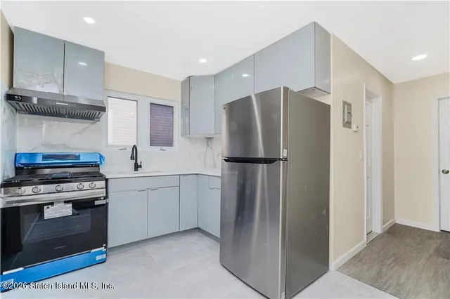 a kitchen with stainless steel appliances a refrigerator and a stove
