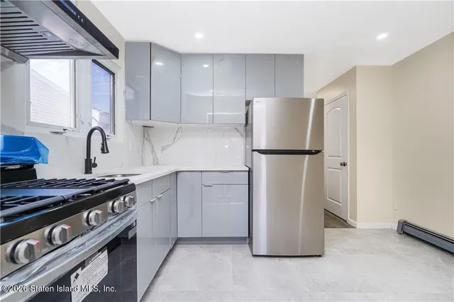 a kitchen with a refrigerator and a stove