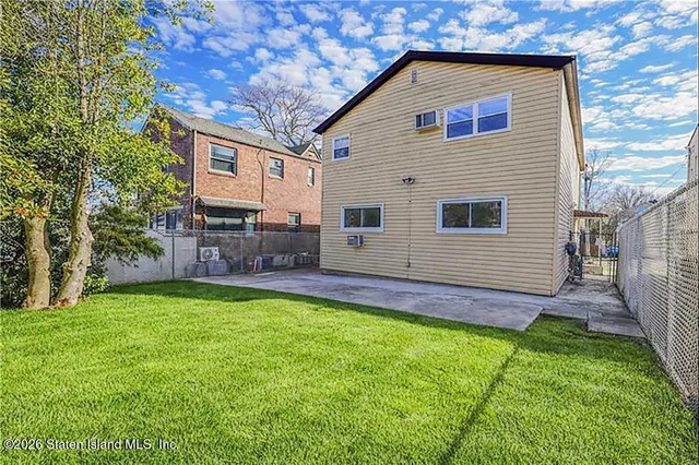 a front view of house with yard and outdoor seating