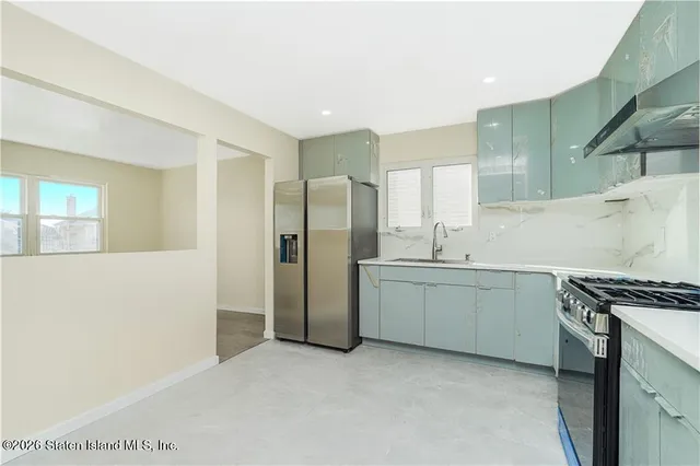 a kitchen with stainless steel appliances granite countertop a refrigerator and a sink