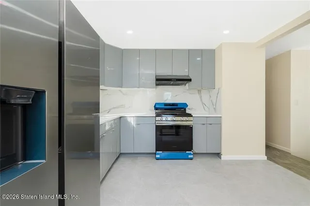 a kitchen with a stove and a refrigerator