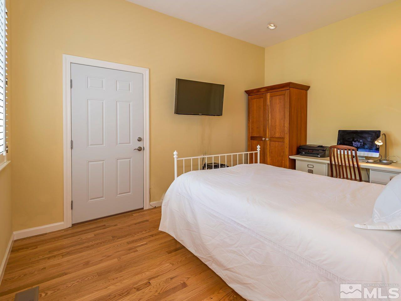 1755 Caughlin Creek Road Reno, NV 89519 - Photo 13 of 25 a bedroom with a bed and a flat screen tv