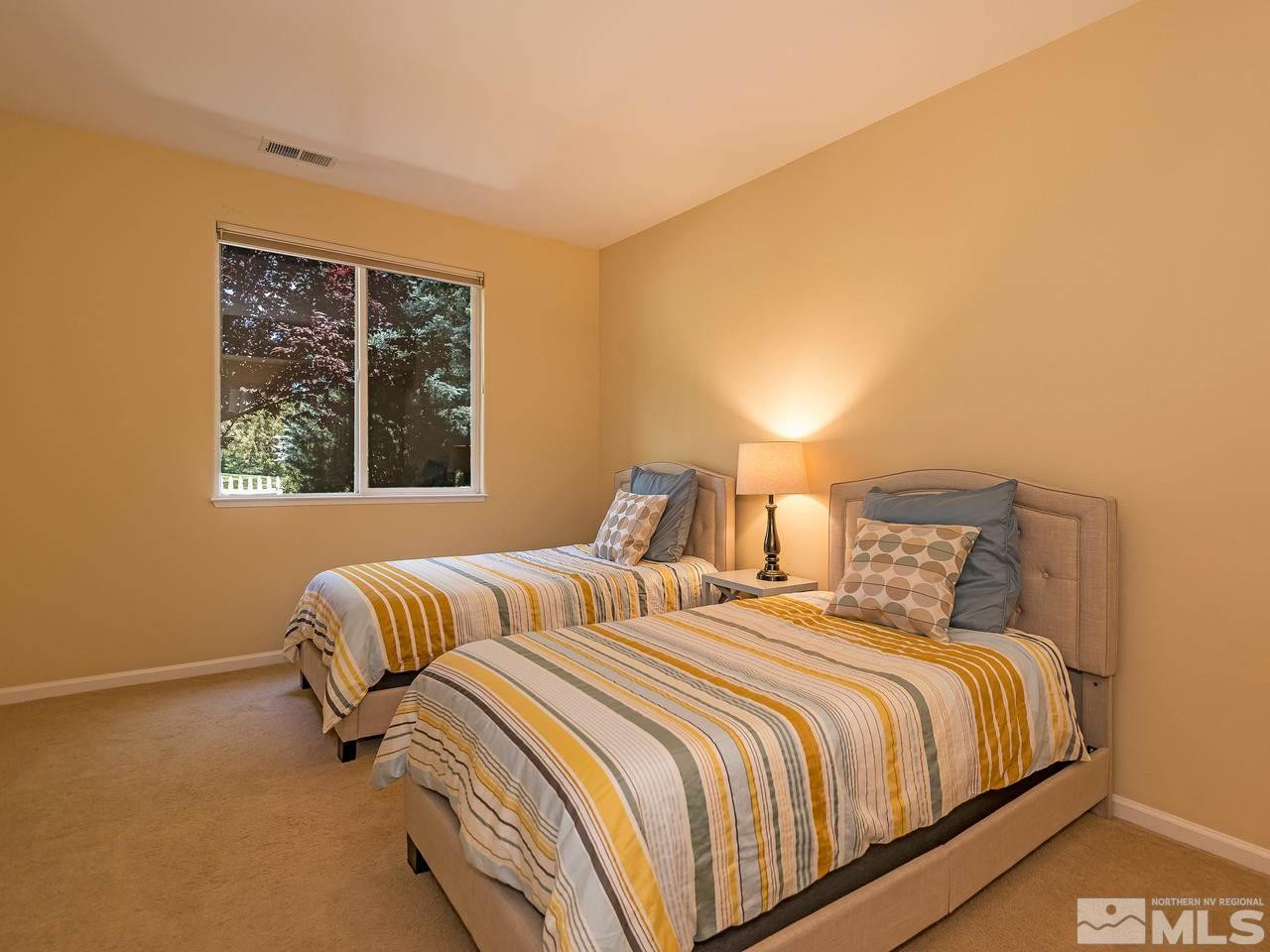 1755 Caughlin Creek Road Reno, NV 89519 - Photo 16 of 25 a bedroom with two beds and a window