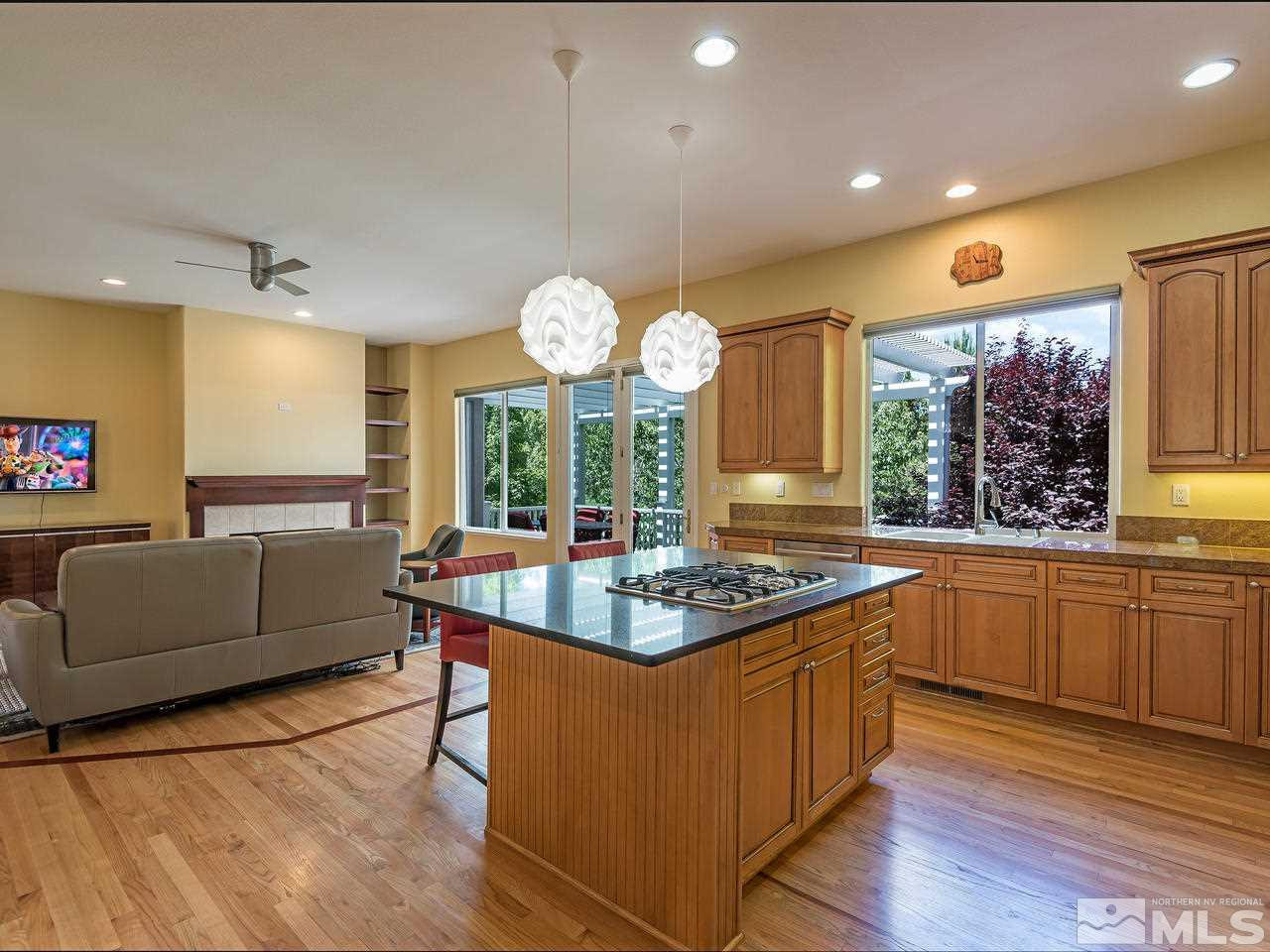 1755 Caughlin Creek Road Reno, NV 89519 - Photo 5 of 25 a kitchen with granite countertop a stove and a sink