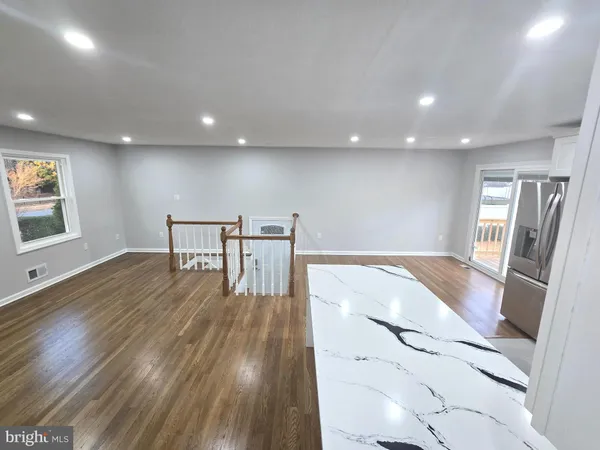 a kitchen with stainless steel appliances granite countertop a refrigerator stove and sink