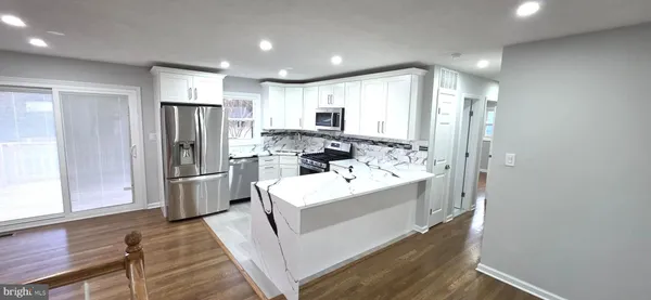 a stove top oven sitting inside of a kitchen