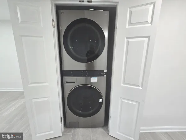 a view of a hallway with entryway and stairs