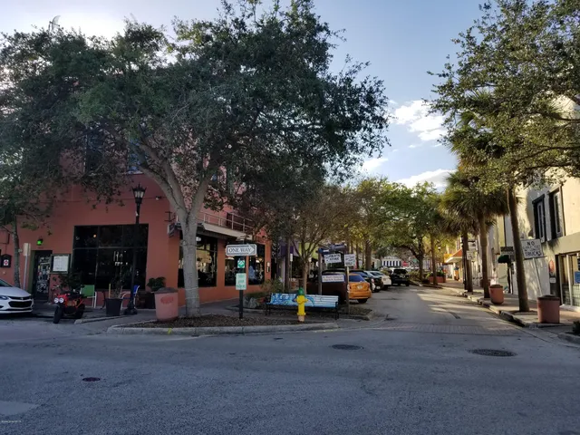 a view of road with card parked on the roadside