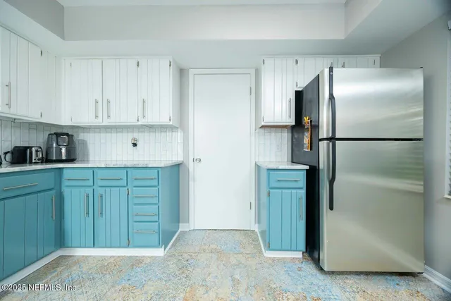 a bedroom with a large bed and a chandelier fan