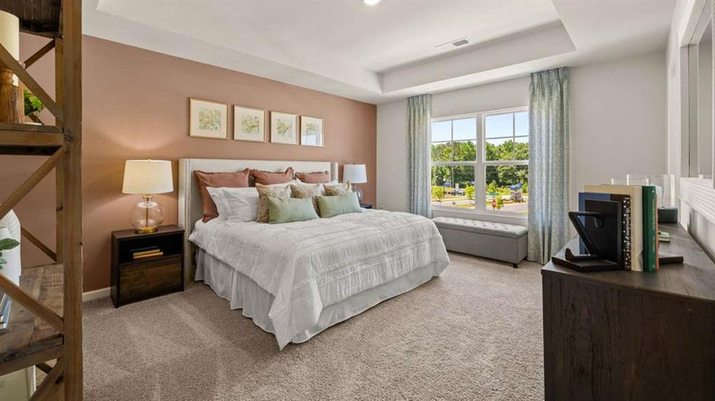 424 Reflection Drive Stockbridge, GA 30281 - Photo 31 of 66 a bedroom with a bed flat screen tv and a large window