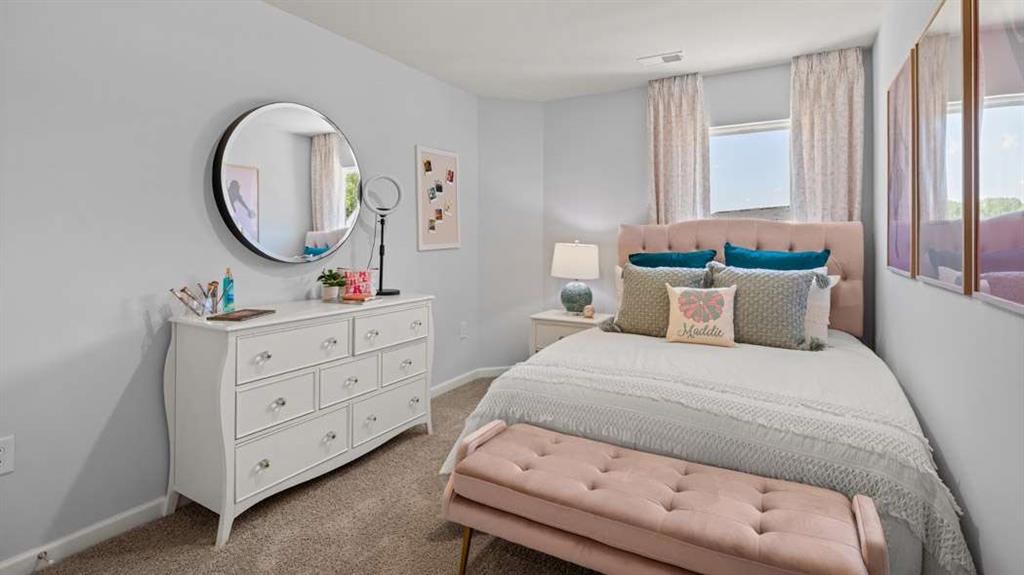 424 Reflection Drive Stockbridge, GA 30281 - Photo 50 of 66 a bedroom with a bed and a dresser