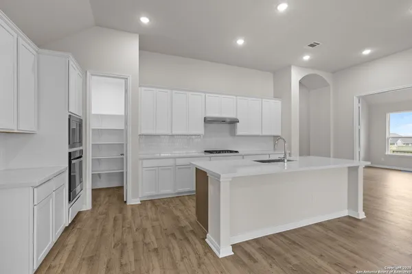 a kitchen with a sink stainless steel appliances and cabinets