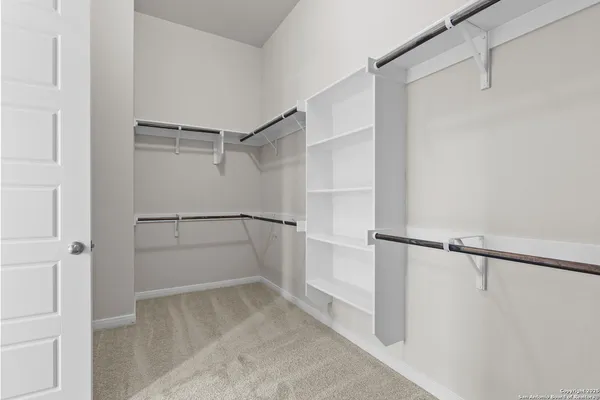 a view of walk in closet with empty racks