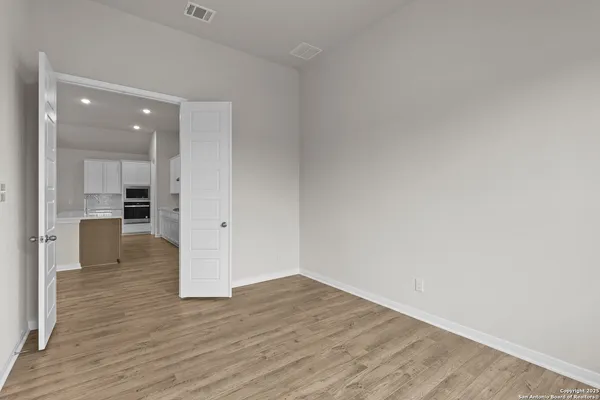 a view of a kitchen and wooden floor
