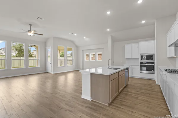 a large kitchen with stainless steel appliances granite countertop a large counter top and sink