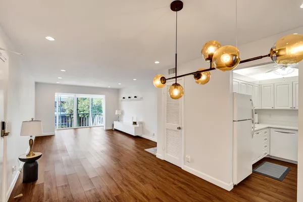 a view of a living room a window and wooden floor