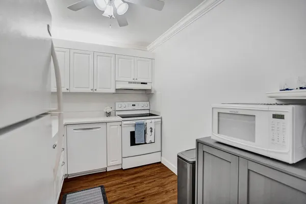 a kitchen with white cabinets stainless steel appliances and sink
