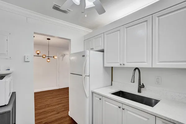 a kitchen with a sink and refrigerator