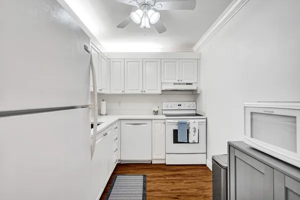 a kitchen with stainless steel appliances white cabinets and a sink