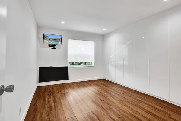 a view of a room with wooden floor and window