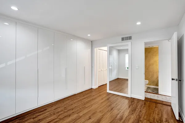 a view of wooden floor and windows in a room