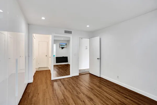 a view of hallway with wooden floor
