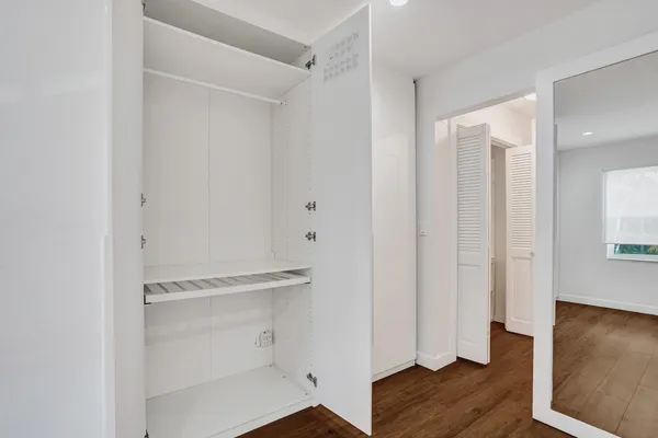 a room with wooden floor and closet