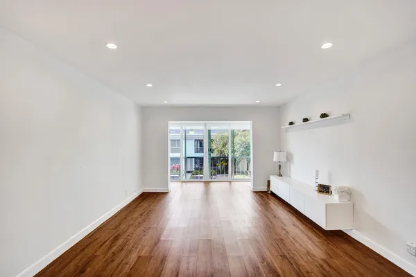 a big room with wooden floor and windows