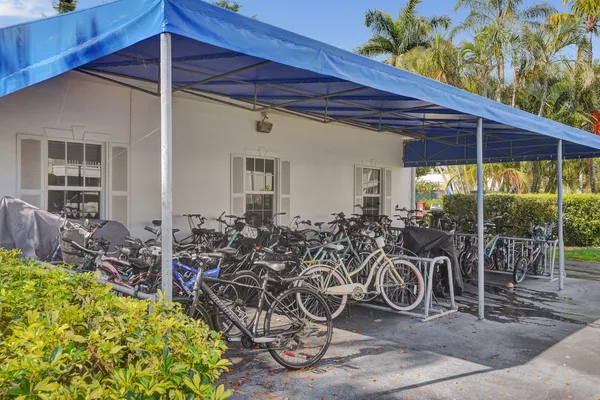 a front view of a house with a yard and potted plants