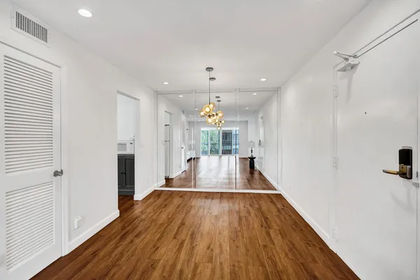a view of a room with wooden floor and staircase