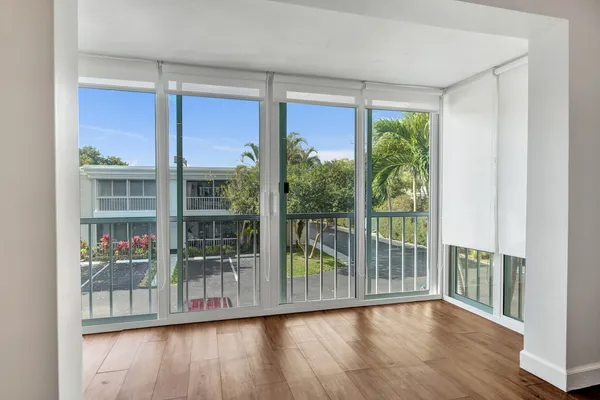 a view of a room with wooden floor and balcony