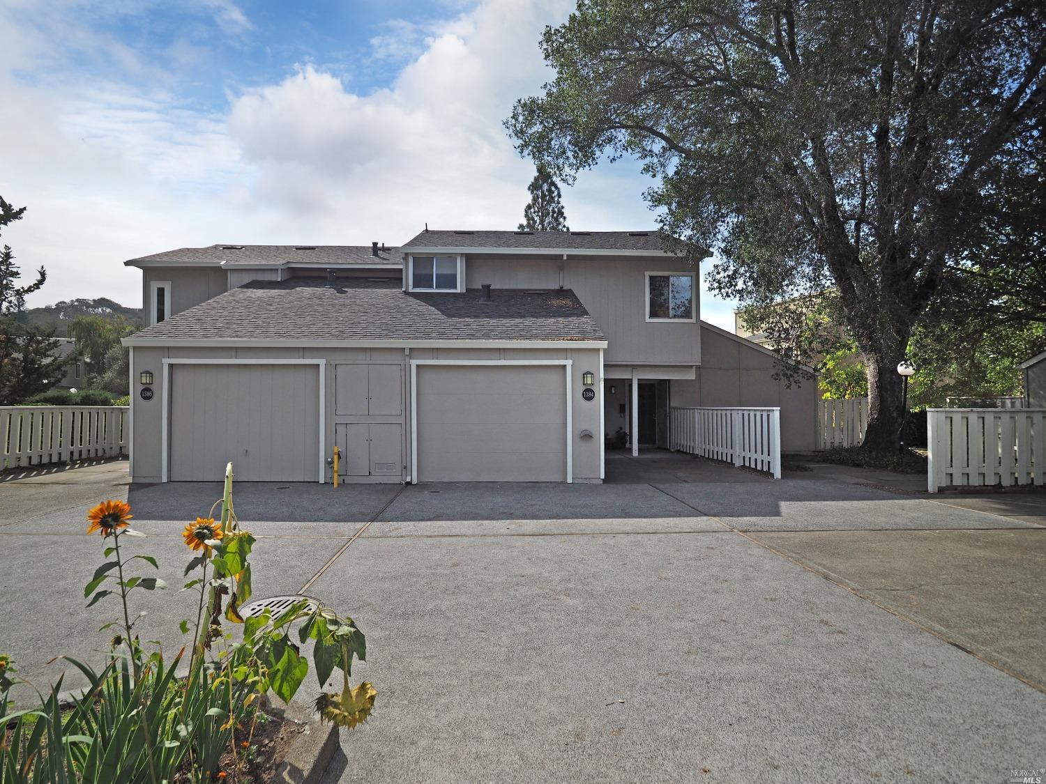 a front view of a house with a yard and a garage