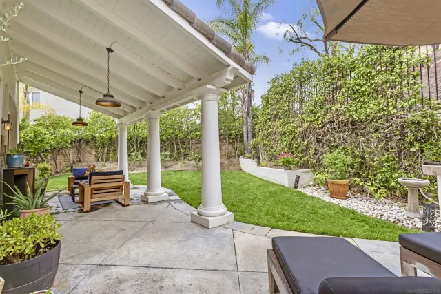 a view of a patio with a table chairs and a backyard