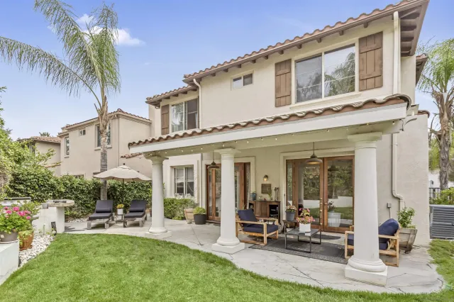 a view of a house with backyard porch and sitting area