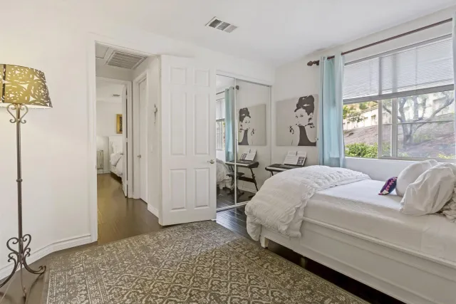 a bedroom with a bed and a window