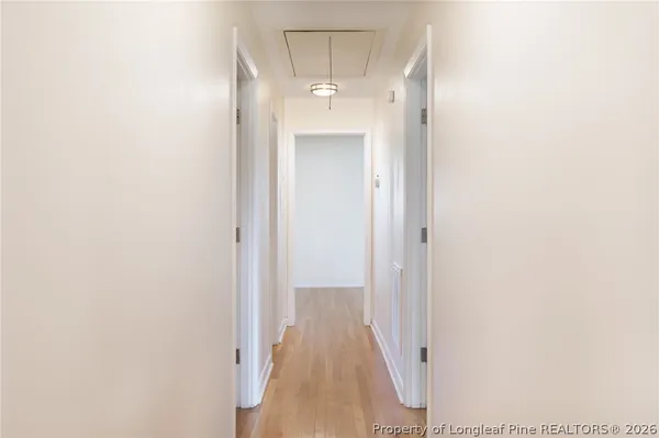 a view of a hallway with wooden floor