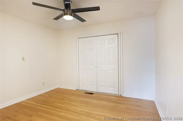 a view of empty room with ceiling fan
