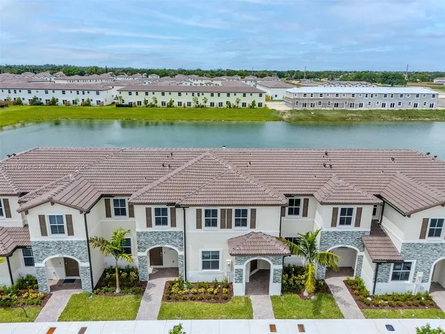 an aerial view of residential house with outdoor space and lake view