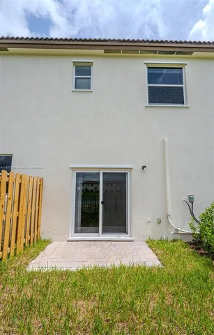 a view of a house with swimming pool and a large windows